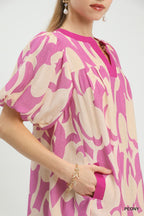 Pink and cream patterned mini dress close-up: V-neck and puff sleeve