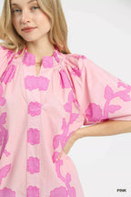 Pink floral blouse close-up with smocked neckline and puff sleeve cuffs