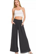 Black wide-leg lounge pants with smocked waistband and flowing legs