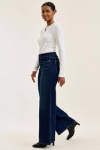 Dark wash wide-leg jeans side view with long flared leg and button closure