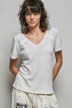 Off-white textured knit V-neck top with lace-trimmed shoulders and short sleeves