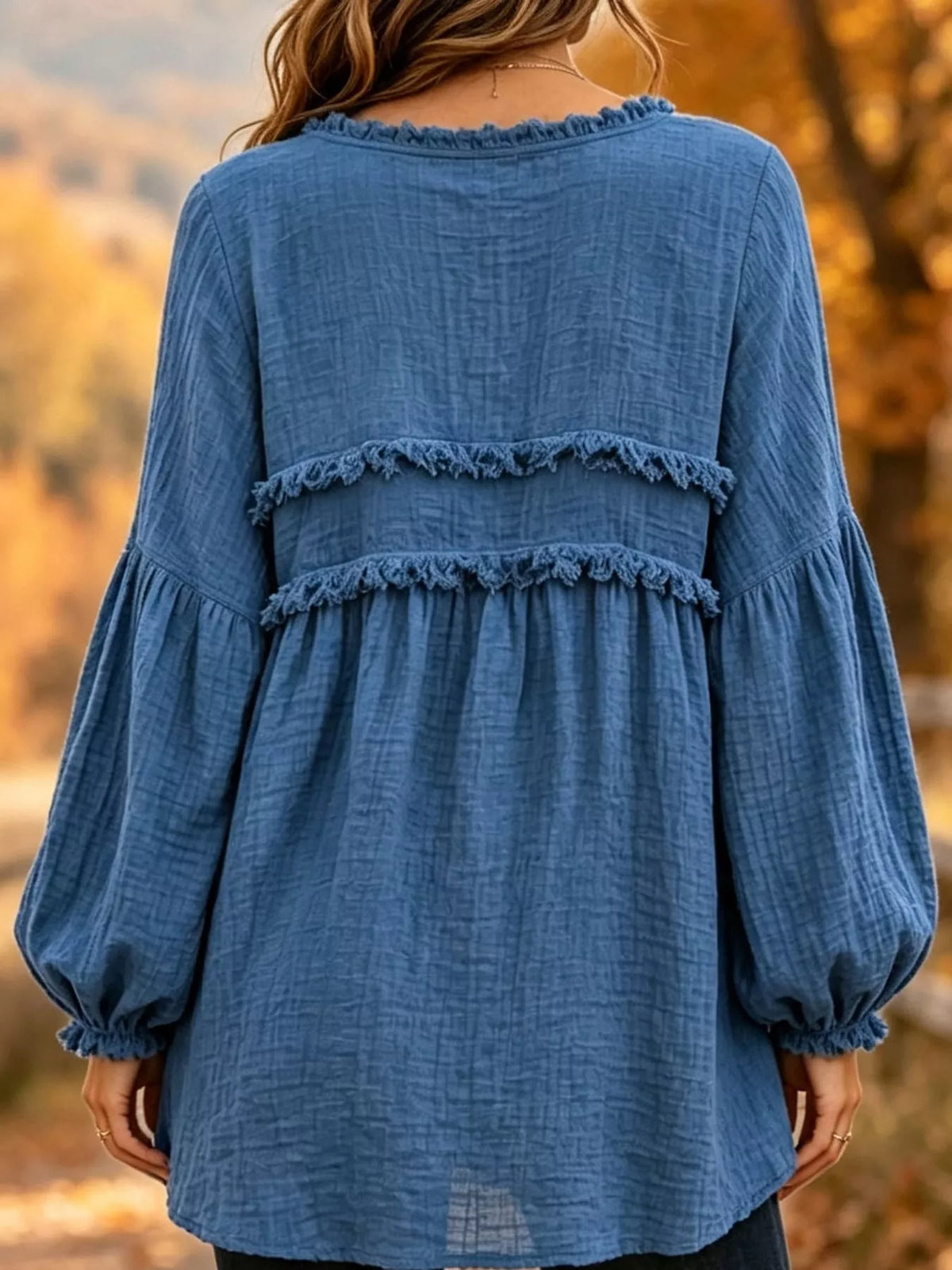 Blue frayed-trim peplum blouse, back view with tiered ruffles and puff sleeves