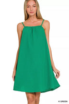 Green woven mini dress with thin spaghetti straps and gathered square neckline