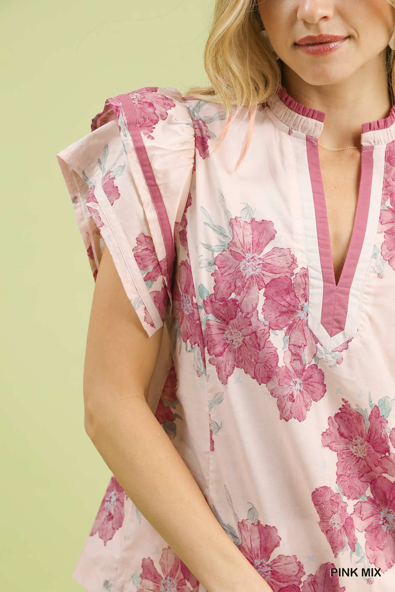 Floral V-neck blouse detail with pink mix print and ruffled shoulder cap sleeves