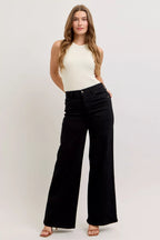 High-waisted wide-leg black denim jeans with relaxed fit and front button closure