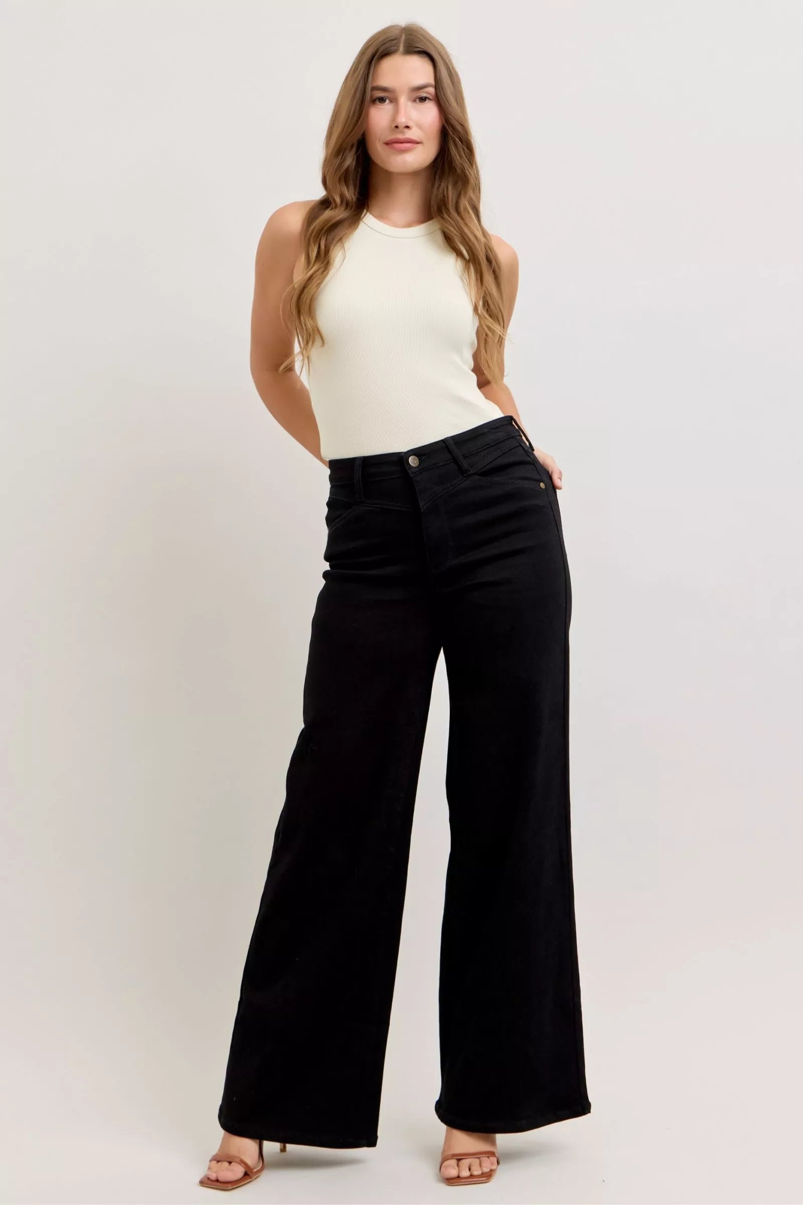High-waisted wide-leg black denim jeans with relaxed fit and front button closure