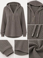 Gray waffle-knit button hoodie detail view: hood drawstrings, buttons, cuffs, hem.