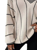 Cream textured knit sweater with black vertical stripe design and ribbed cuffs.