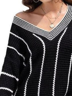 Black V-neck textured knit sweater with white vertical stripes and wide V neckline trim