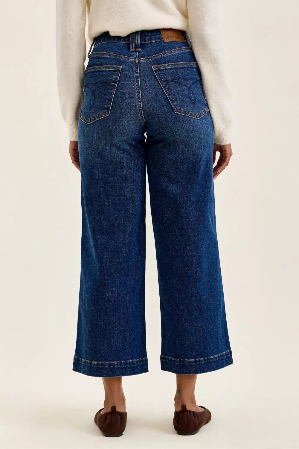 Dark indigo wide-leg ankle jeans, back view with patch back pockets