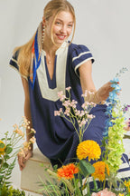 Navy linen-cotton midi dress with V-neck, white trim, and short sleeves with border