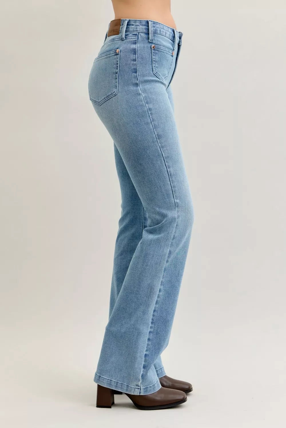 Light blue mid-rise bootcut jeans with side seam and dark topstitching