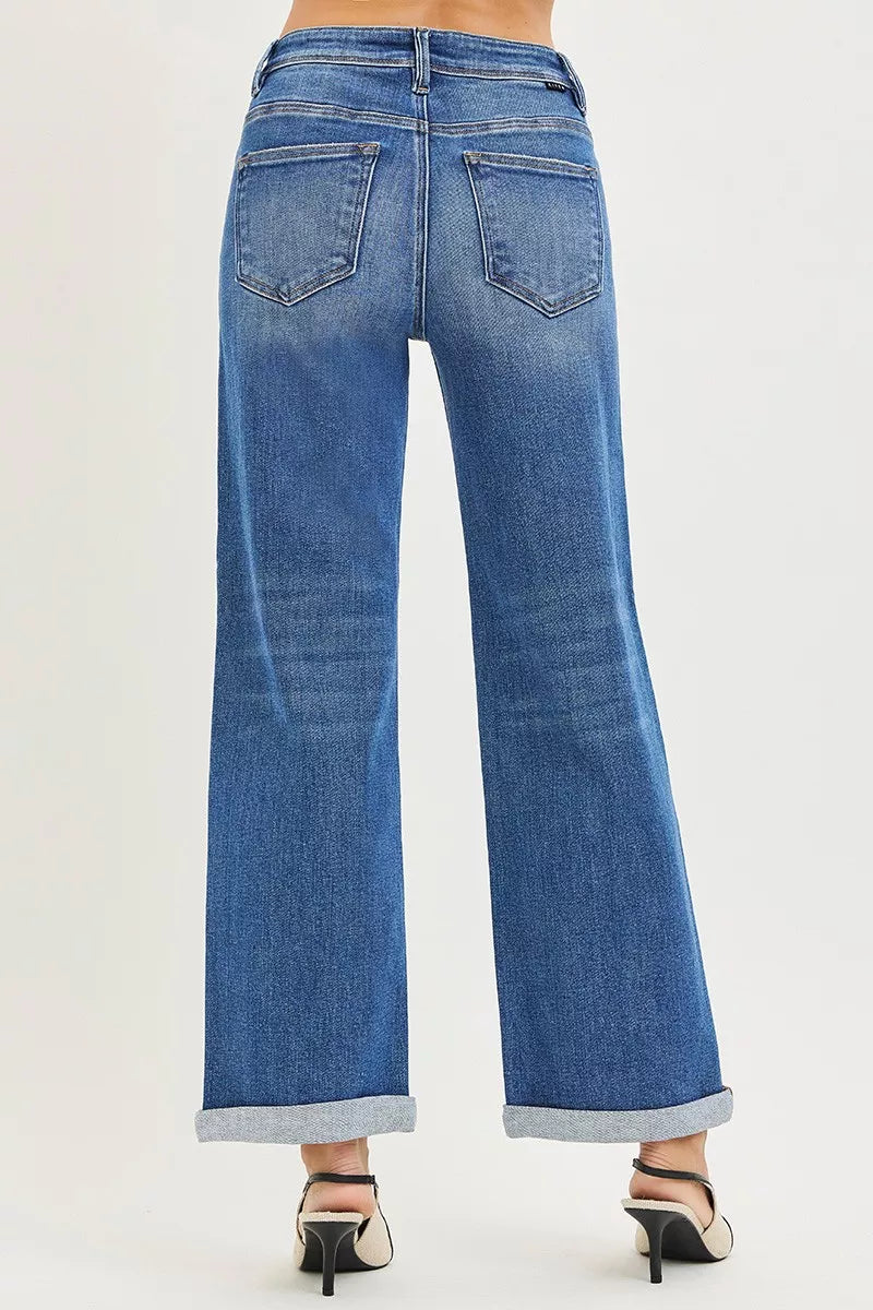 Blue denim jeans with back pockets and cuffed wide straight legs