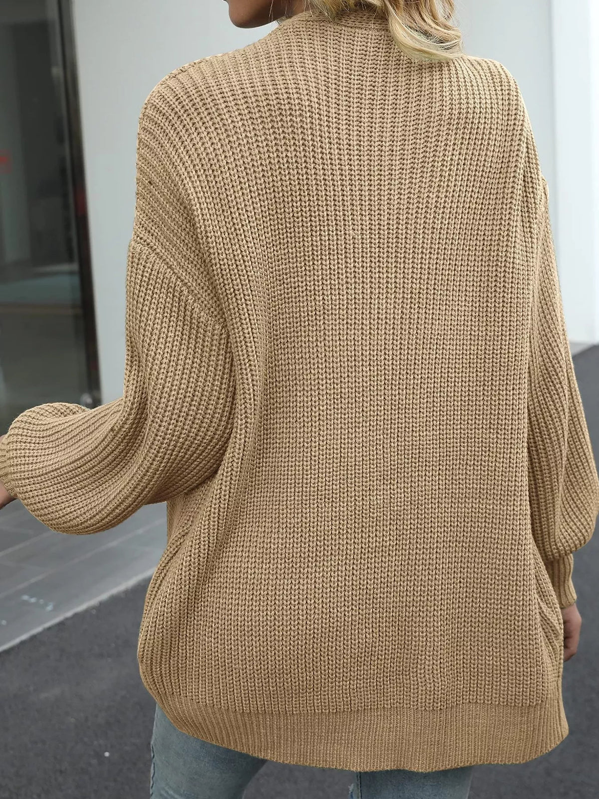 Chunky knit cardigan with lantern sleeves, open back view, beige-brown color.