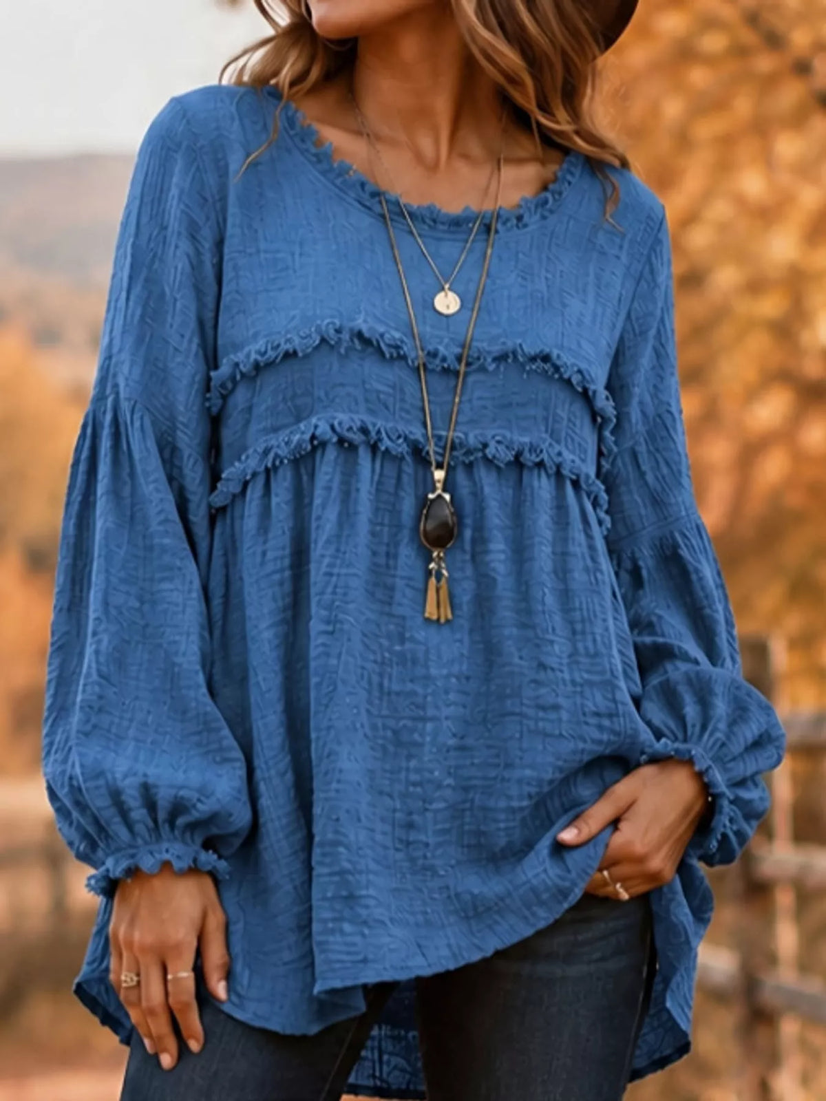 Blue frayed-trim peplum blouse with tiered ruffle yoke and long gathered puff sleeves