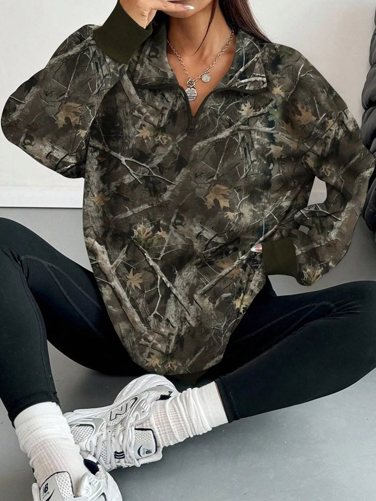Dark army green camo zip-neck oversized sweatshirt, half-zip collar and long sleeves