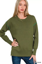 Olive knit top with contrast green trim at neckline and raglan sleeve cuffs