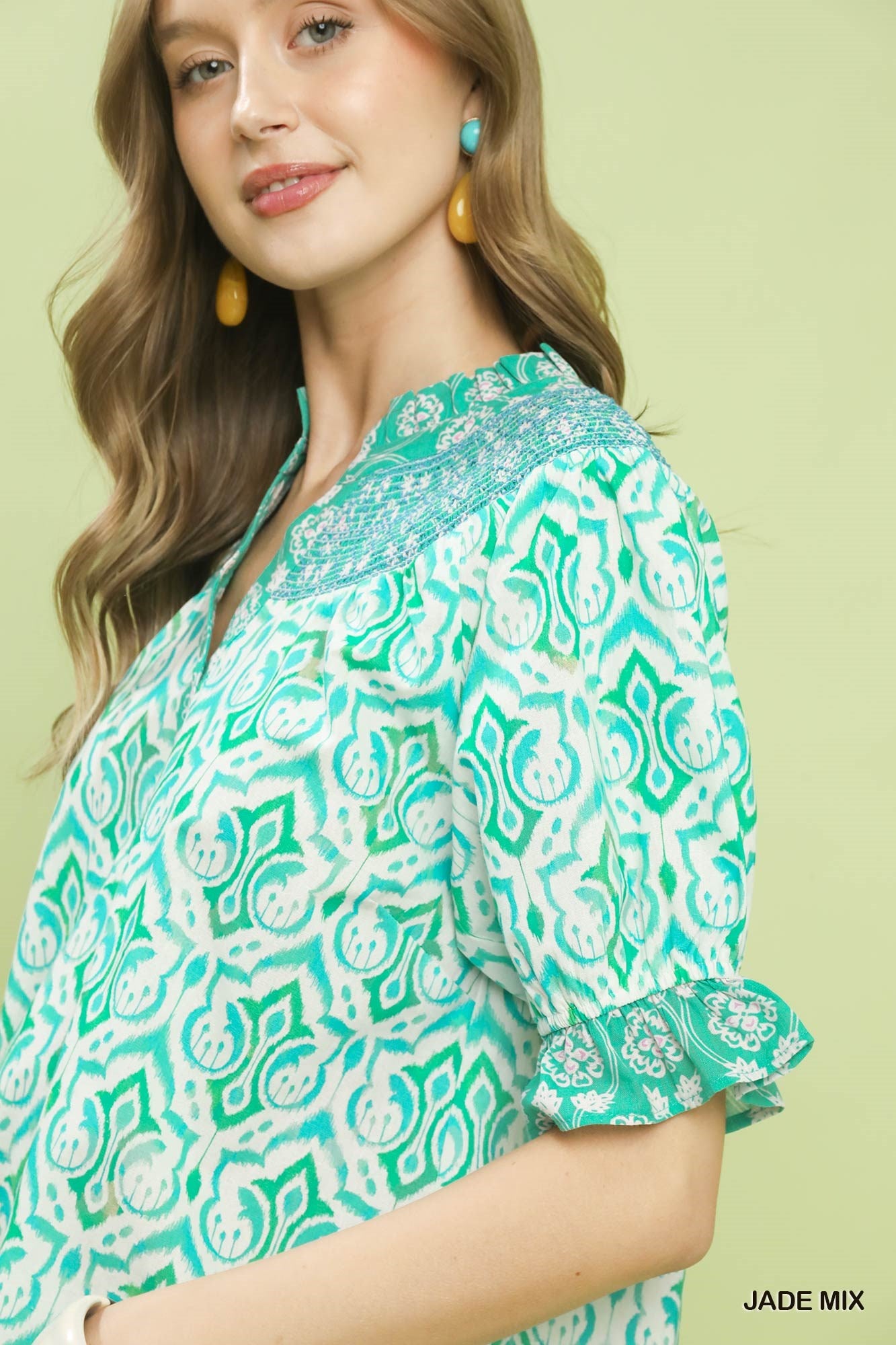Turquoise geometric puff sleeve smocked blouse with ruffled cuff detail