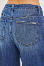 Back pocket detail on women’s baggy jeans in dark blue denim with stitched seams