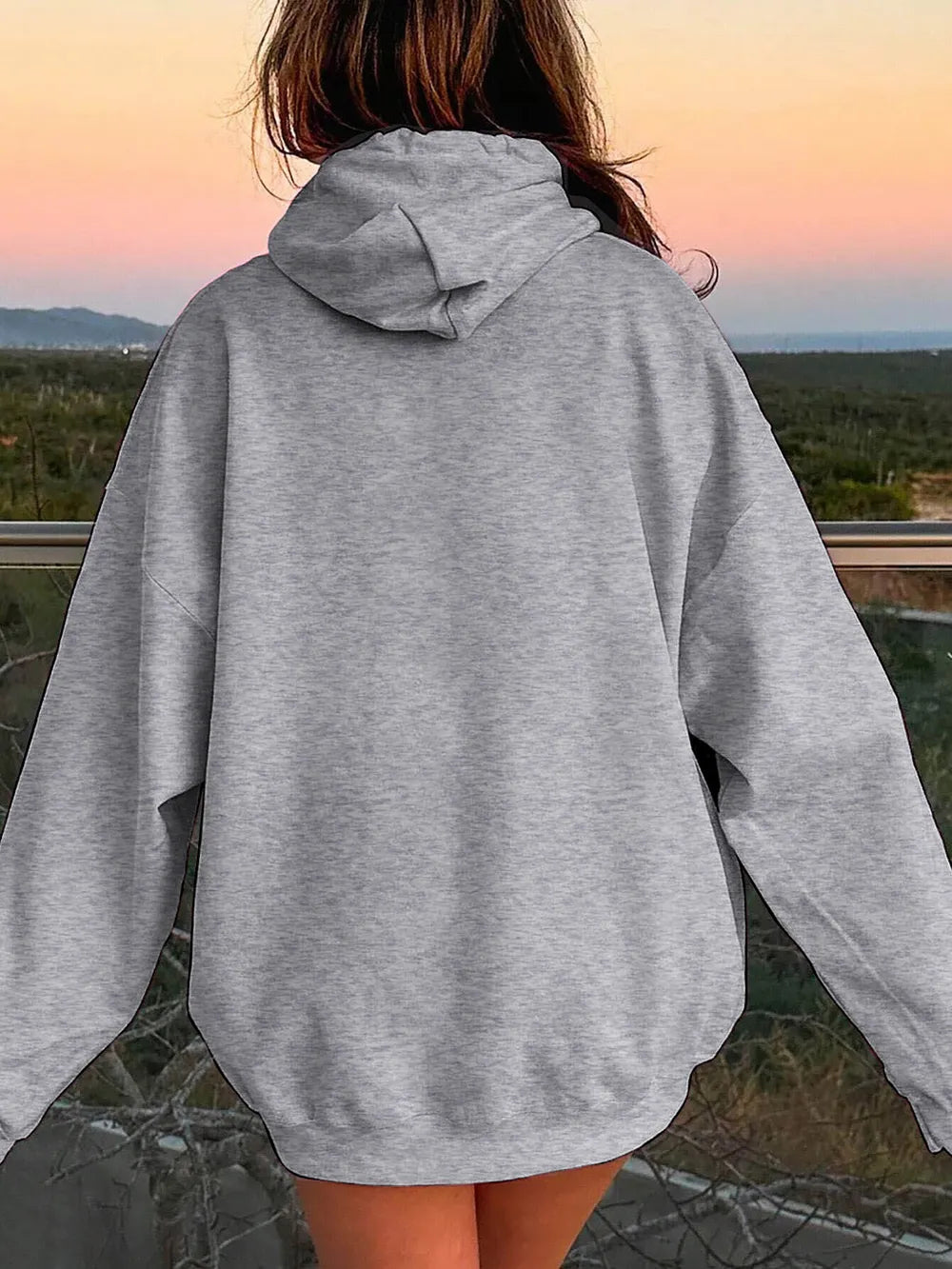 Light gray hoodie from the back with drawstring hood and dropped-shoulder style.
