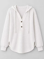 White waffle-knit button hoodie with hood, long sleeves, and two front buttons.