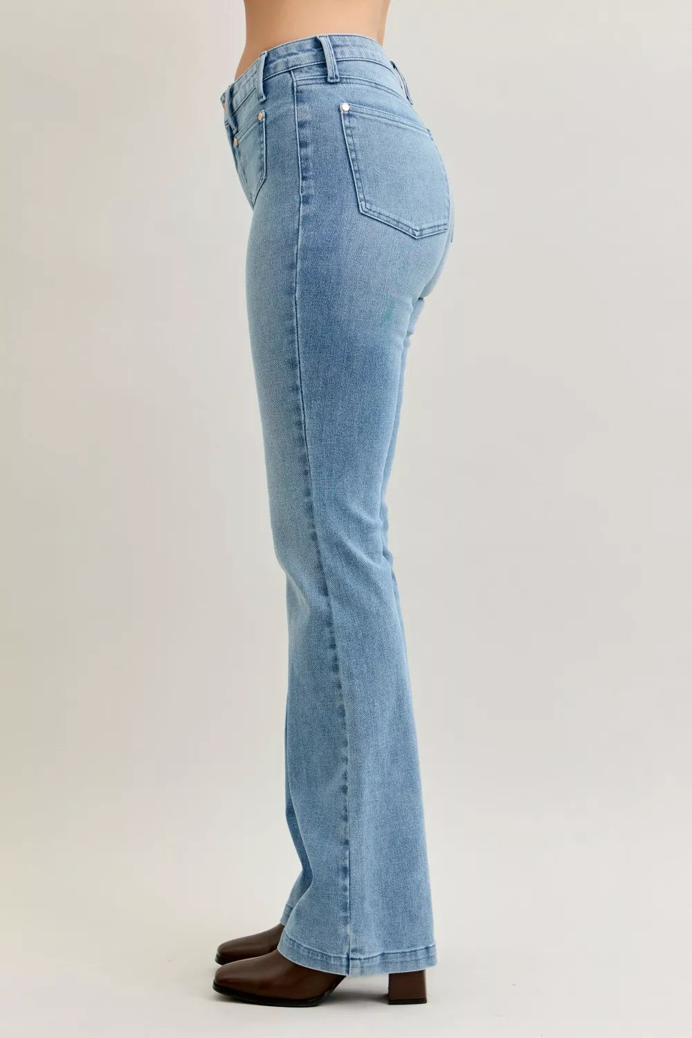Light blue mid-rise bootcut jeans with rear patch pockets and stitched seams