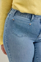 Light blue jeans close-up with button fly, front patch pocket, and belt loops
