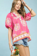 Pink floral V-neck blouse with short puff sleeves and border-print hem
