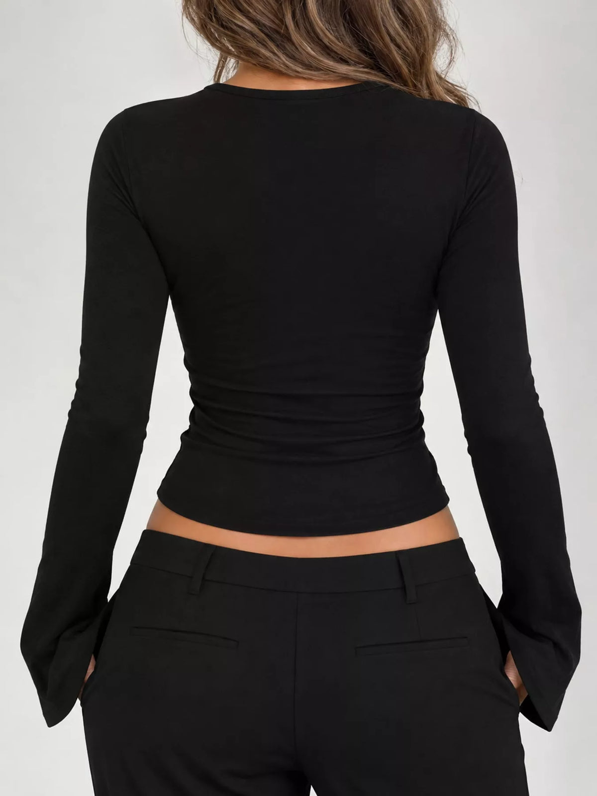 Black lace-trim V-neck long-sleeve tee, back view with ruched waist seam.