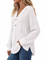 White waffle-knit button hoodie with hood and long sleeves; front button closure.