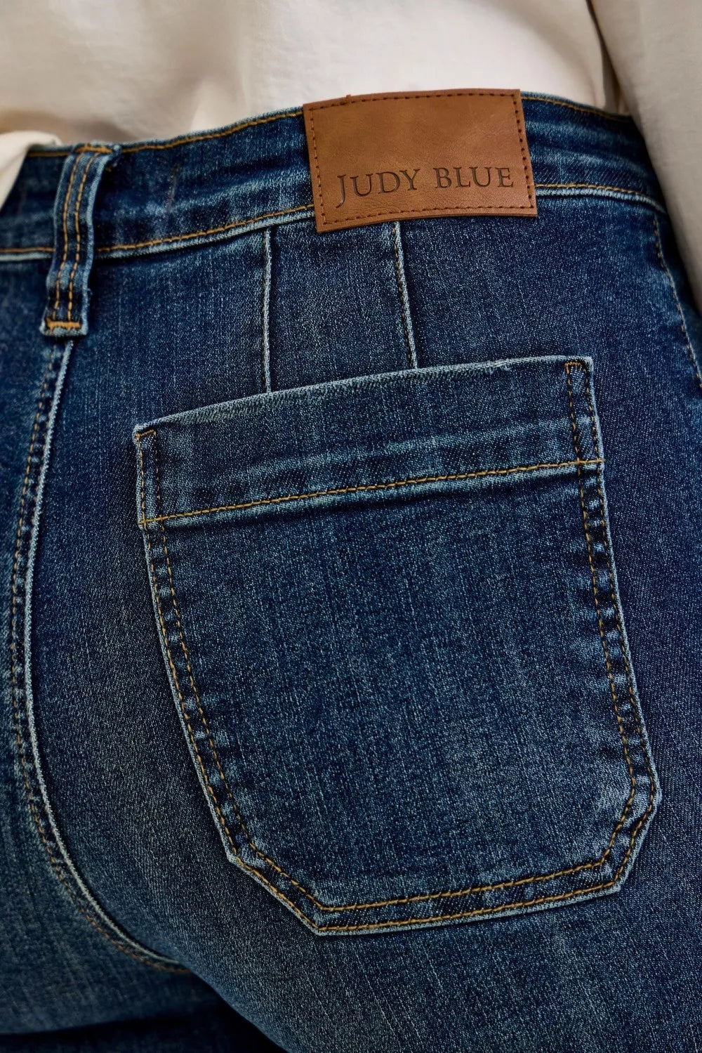 Women’s dark blue denim jeans with “Judy Blue” waistband label and front patch pocket
