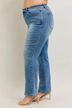 Medium blue high-waist straight jeans, back view with stitched seams and slit hem