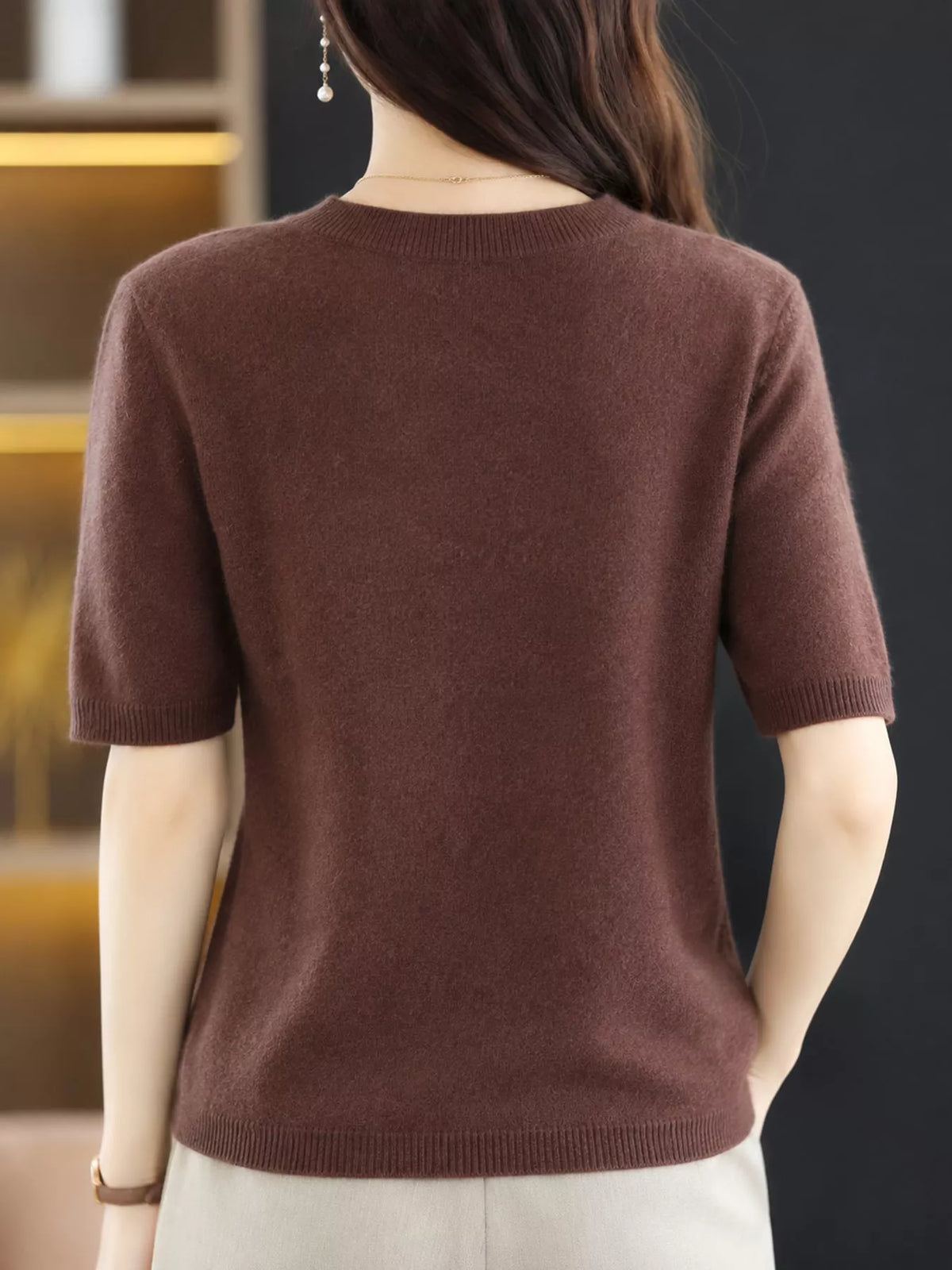 Chocolate brown round-neck short-sleeve sweater, back view with ribbed hem