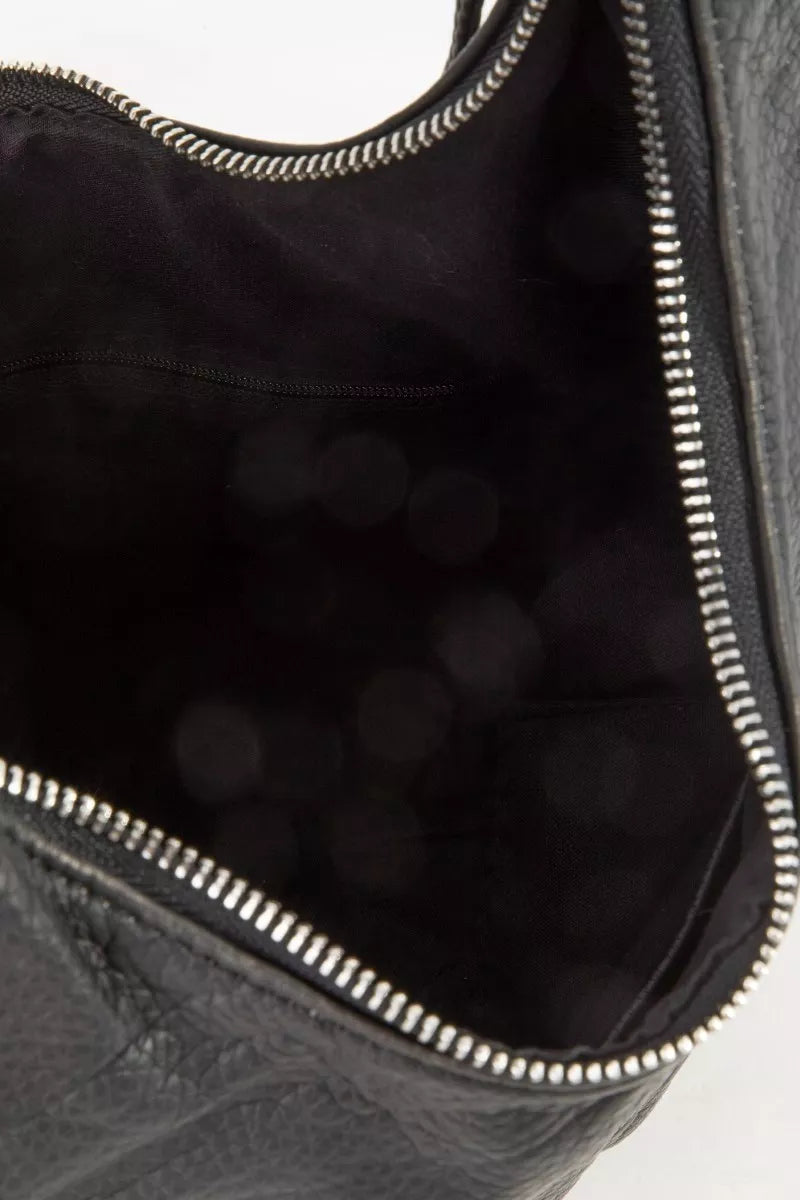 Close-up of black crescent shoulder bag interior with top zipper and stitched trim