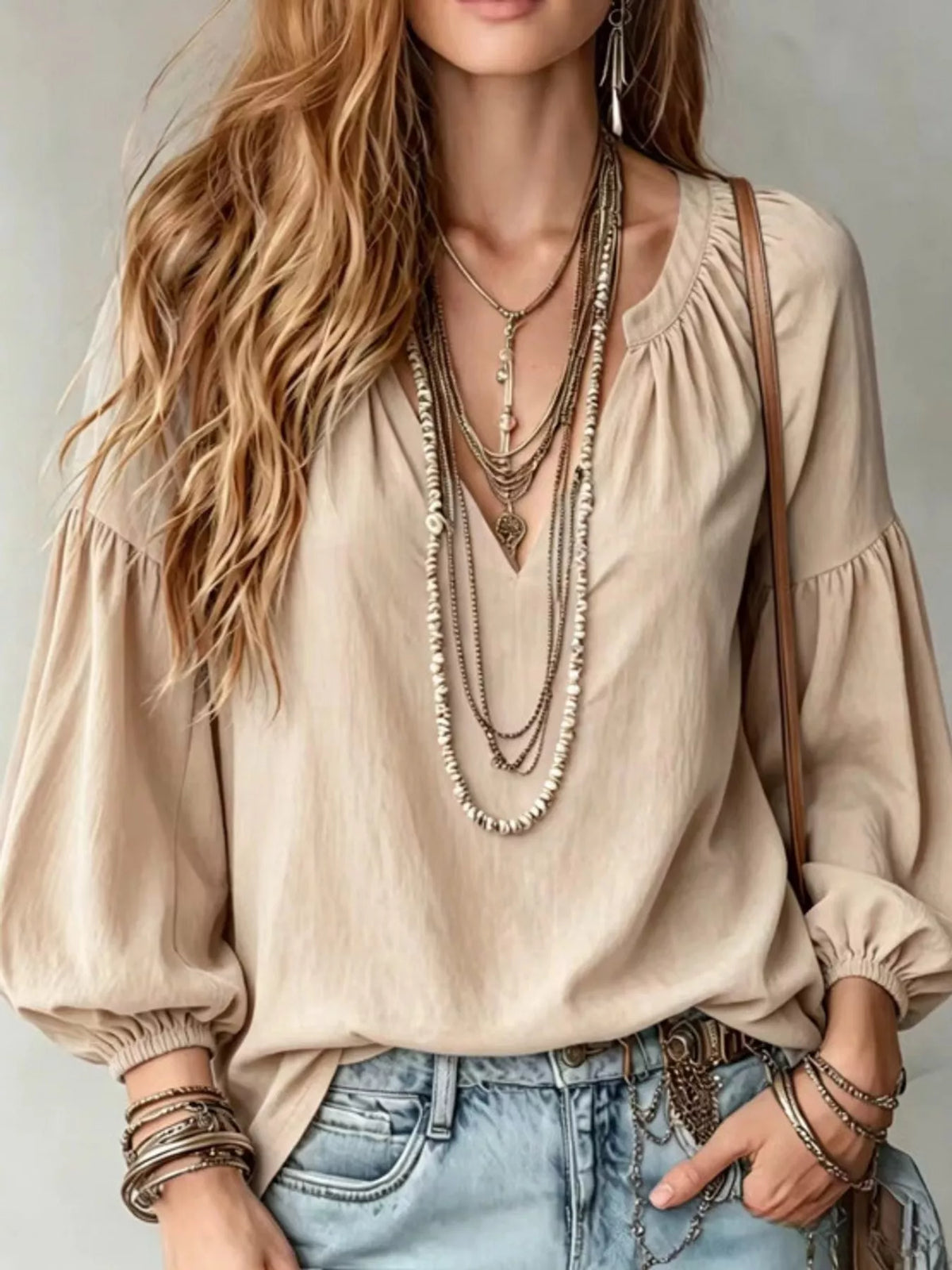 Cream notched V-neck blouse with gathered balloon sleeves and elastic cuffs