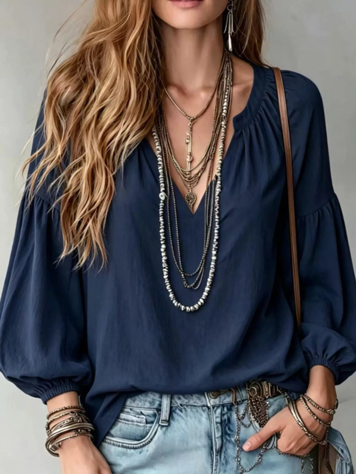 Navy notched V-neck blouse with balloon sleeves and gathered cuffs