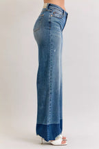 High-waist straight jeans in medium blue denim, back view with raw hem