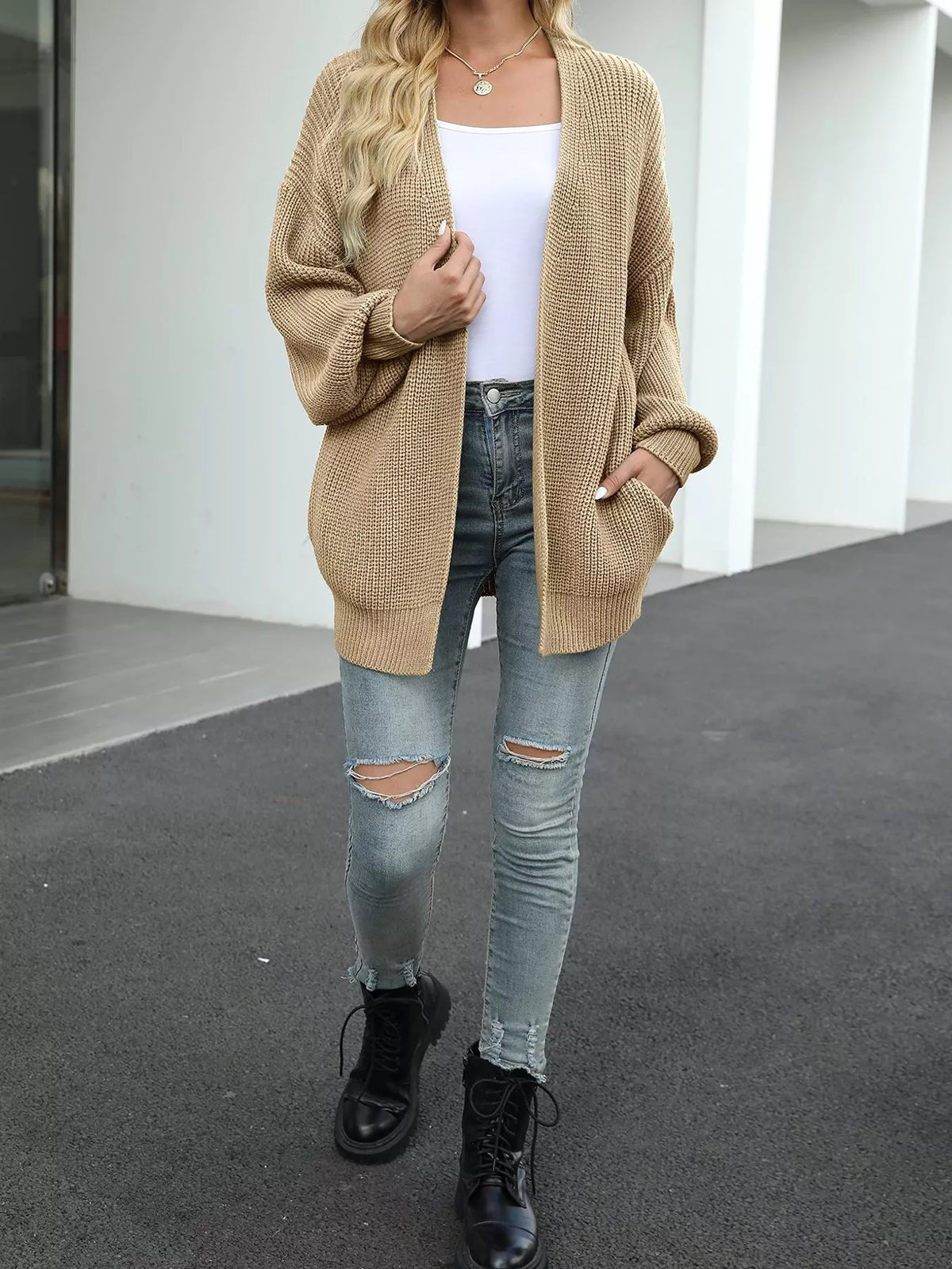 Chunky knit cardigan with long lantern sleeves, beige open front.