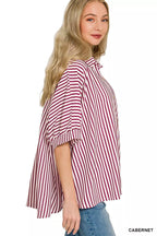 Women’s striped button-down shirt, burgundy and white vertical stripes, side view with cuffed sleeve