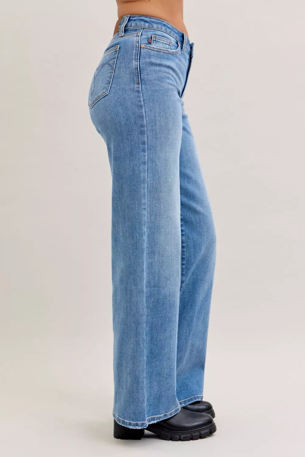 Light blue mid-rise wide-leg jeans shown in side view with wide hems