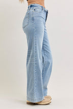 Light wash mid-rise wide-leg jeans, side view with button fly