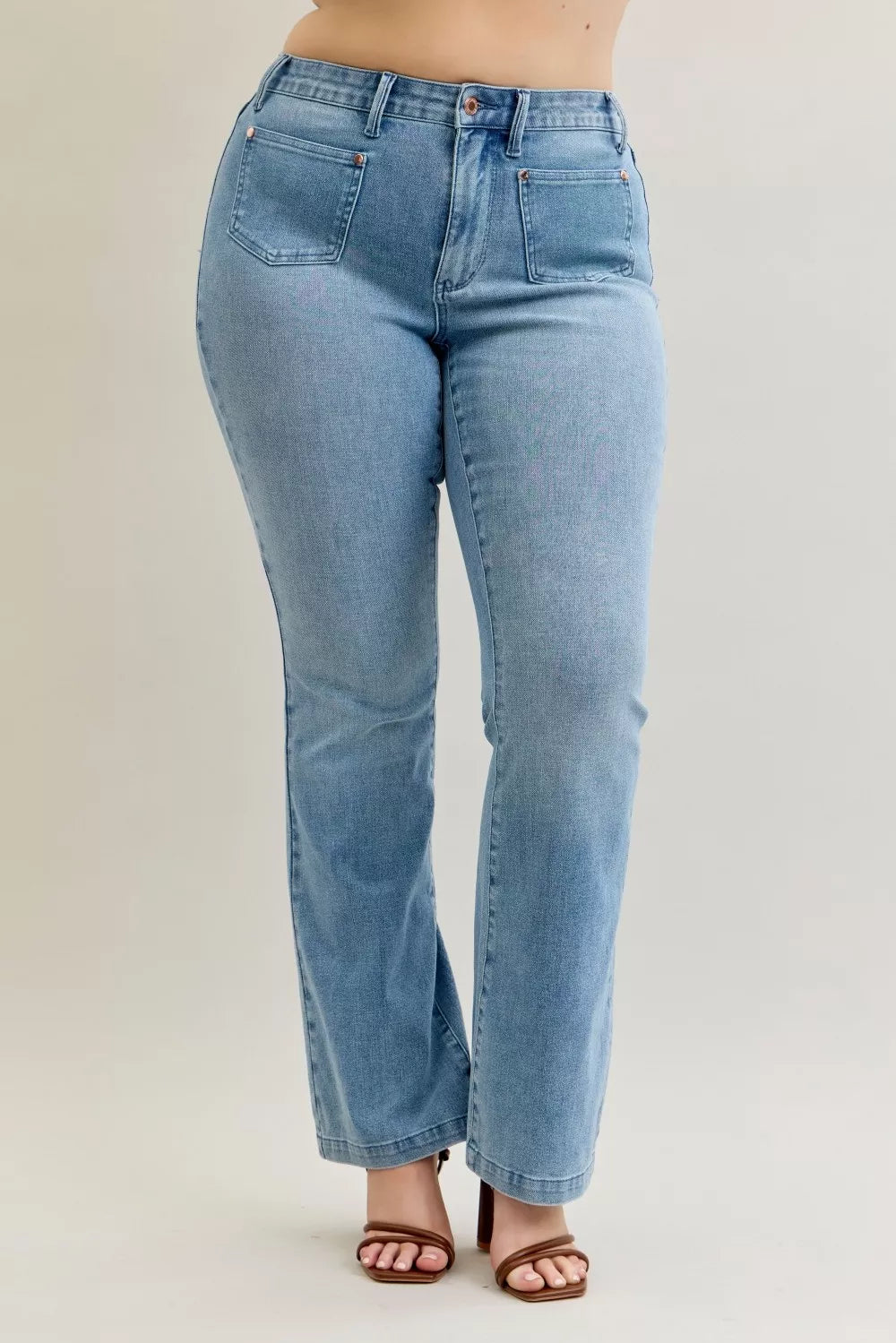 Light blue mid-rise bootcut jeans with front patch pockets and a button-zip front