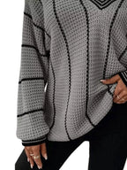 Gray textured knit sweater with black vertical stripe design and ribbed sleeve cuffs.