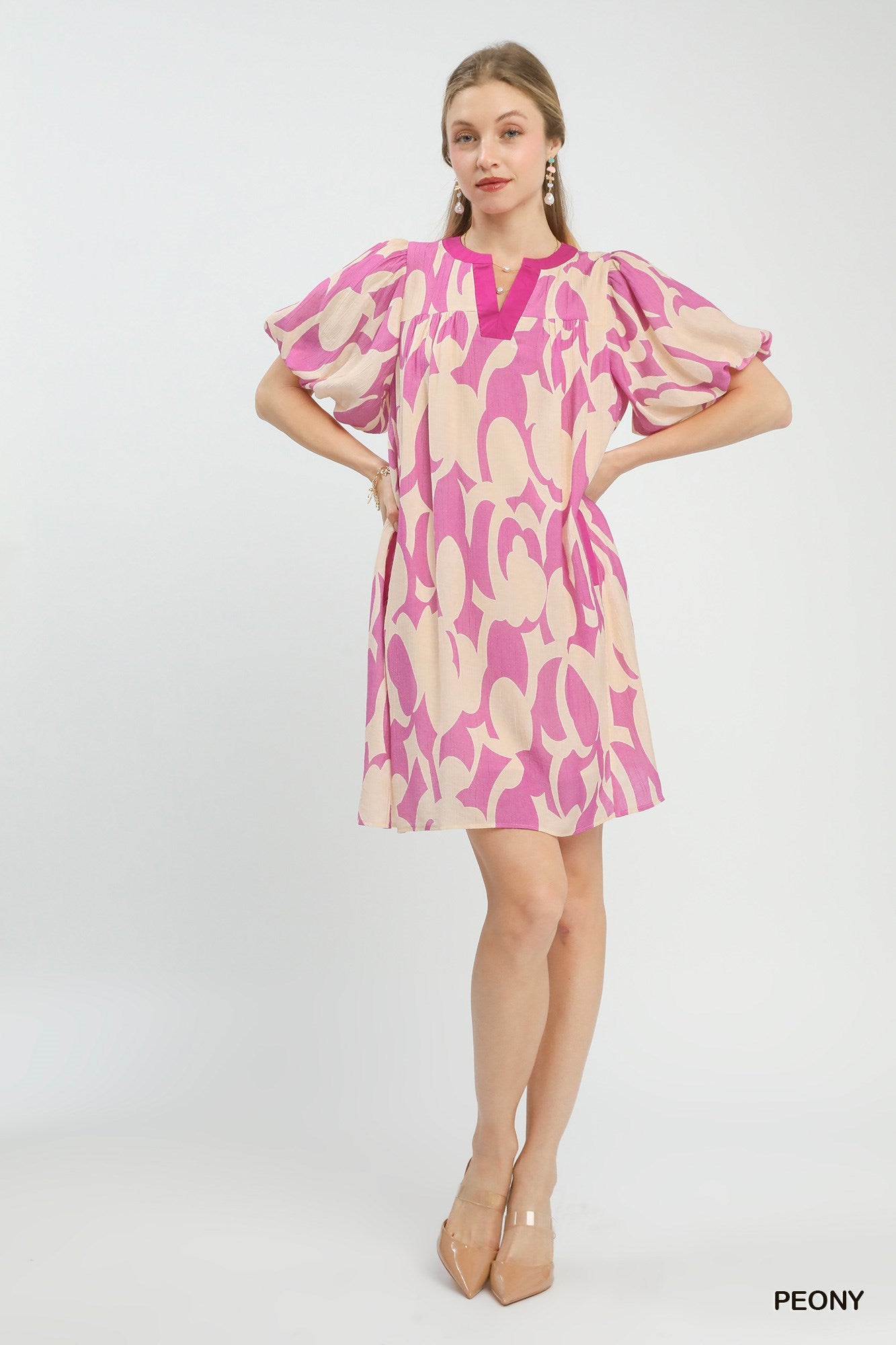 Pink and cream patterned mini dress with V-neck, puff sleeves, and mini length