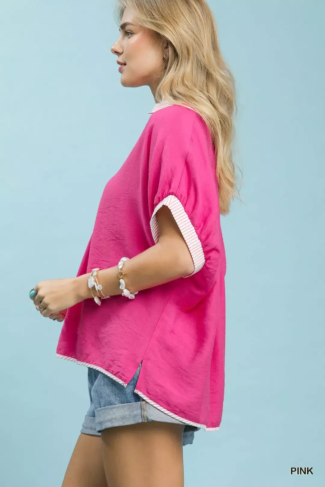 Pink oversized top with contrast stripe-trimmed sleeves and V-neck button placket, side