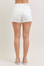 White high-waisted denim shorts, back view, stitched pockets and seams.