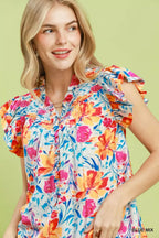 Floral blouse front with smocked yoke and ruffled sleeves, blue base with bright flowers