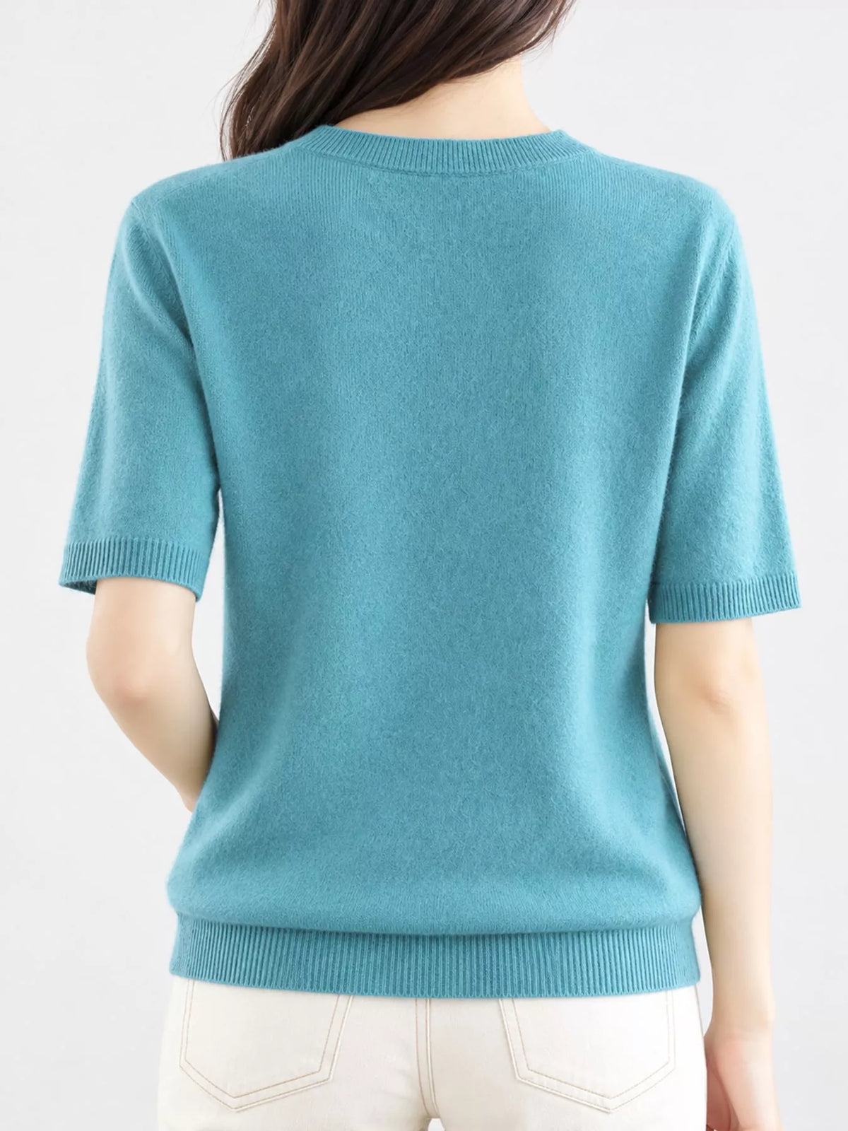 Back view of teal round-neck short-sleeve knit sweater with ribbed trim