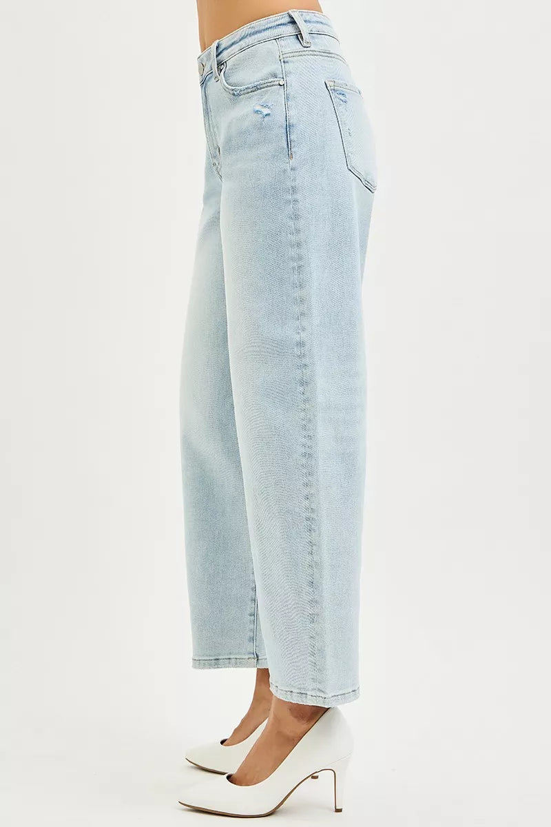 Light wash high-rise crop barrel jeans, side view with stitched seam and cuffed hem