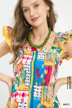 Multi-color abstract print smocked bodice with ruffle-trim neckline